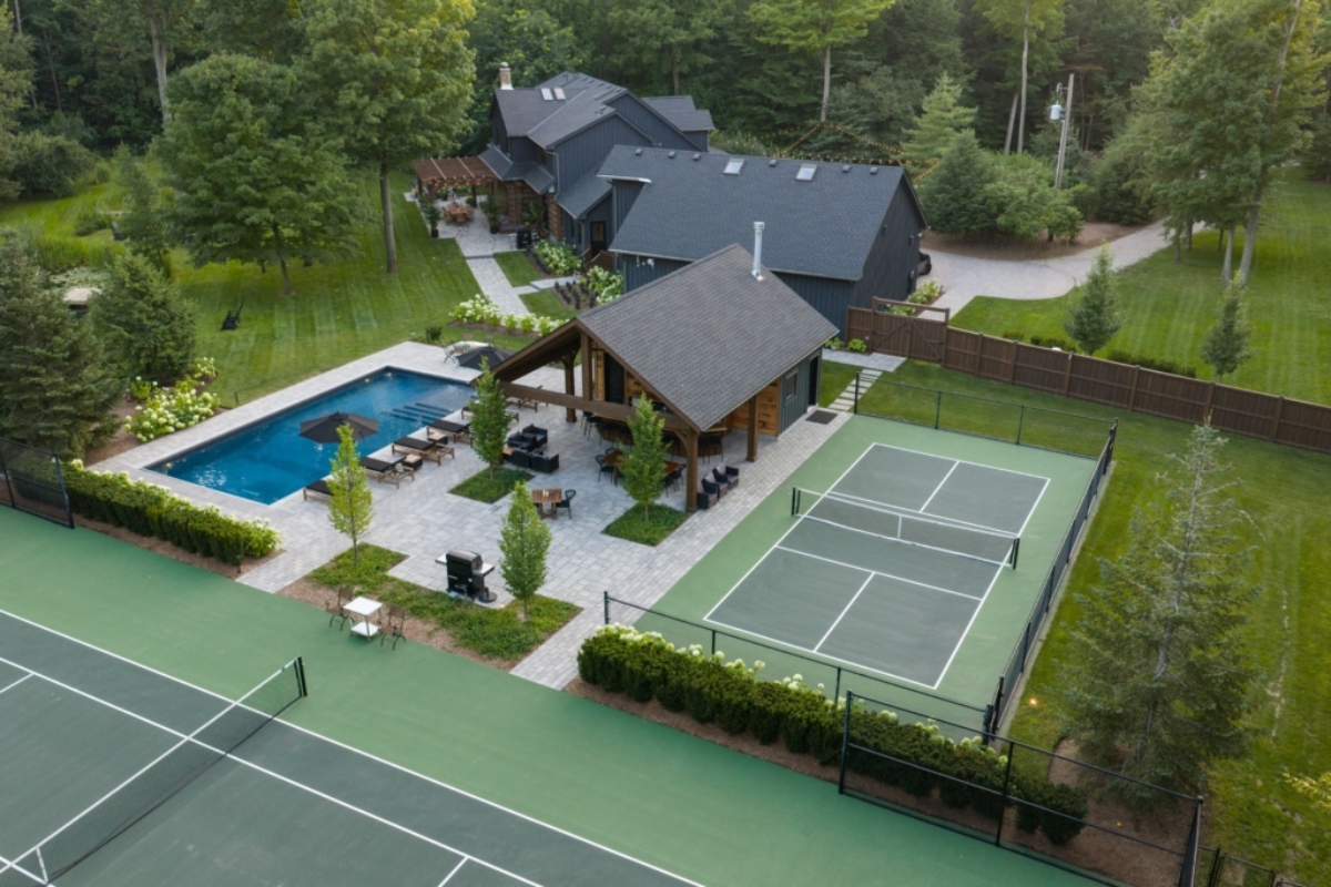 Aerial view of pool, cabana, tennis and pickleball courts Earthscape Landscaping (cover)