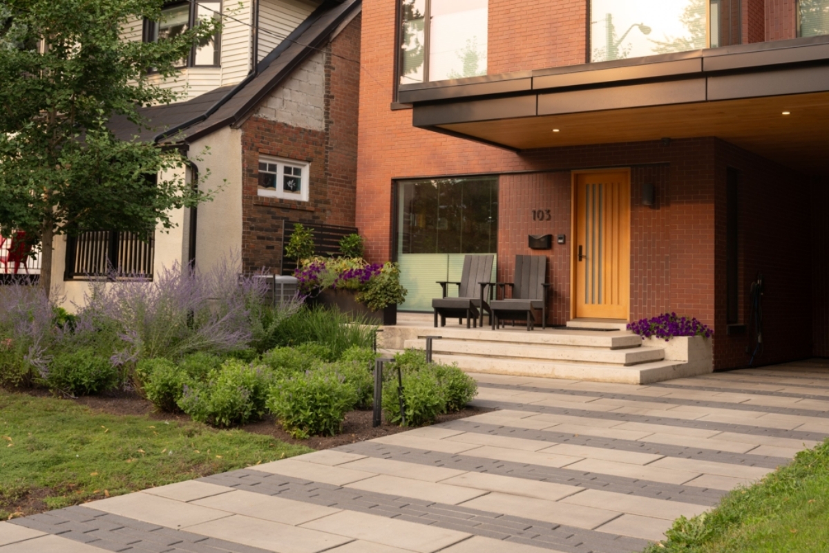 Banded paver walkway and layered shrub planting beds Earthscape Landscaping